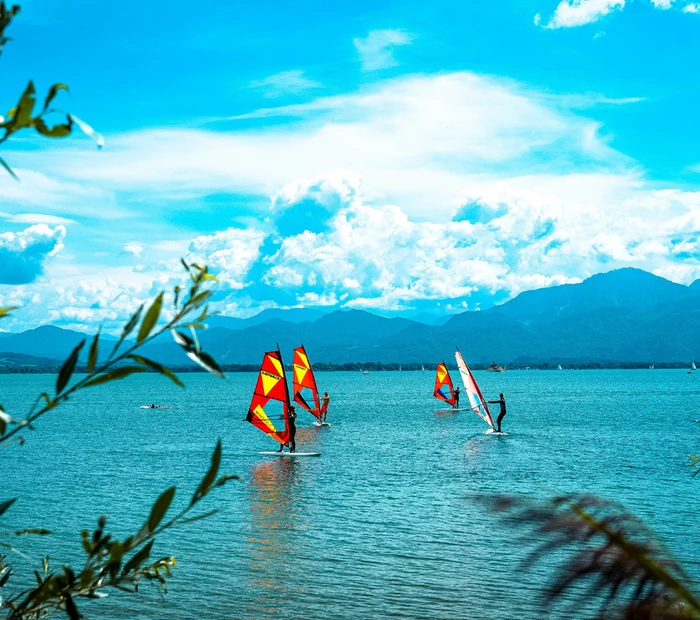 Windsurfer auf dem Chiemsee mit Blick in die Chiemgauer Alpen.