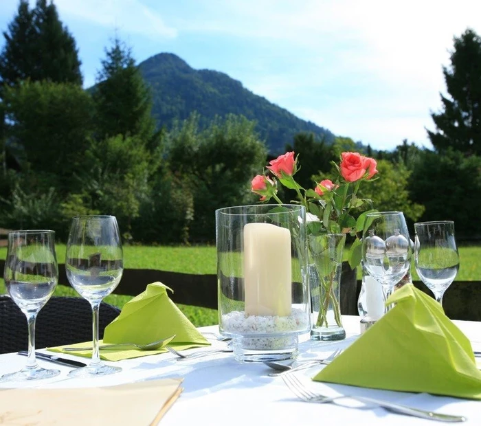 Gedeckter Tisch auf der Terrasse mit Blick in die Berge