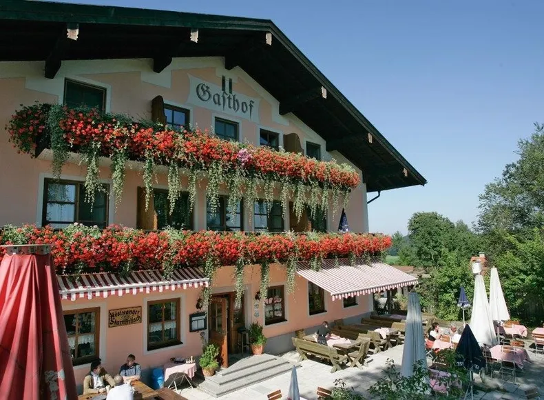 Aussenansicht Gasthof im Sommer mit schattigem Gastgarten